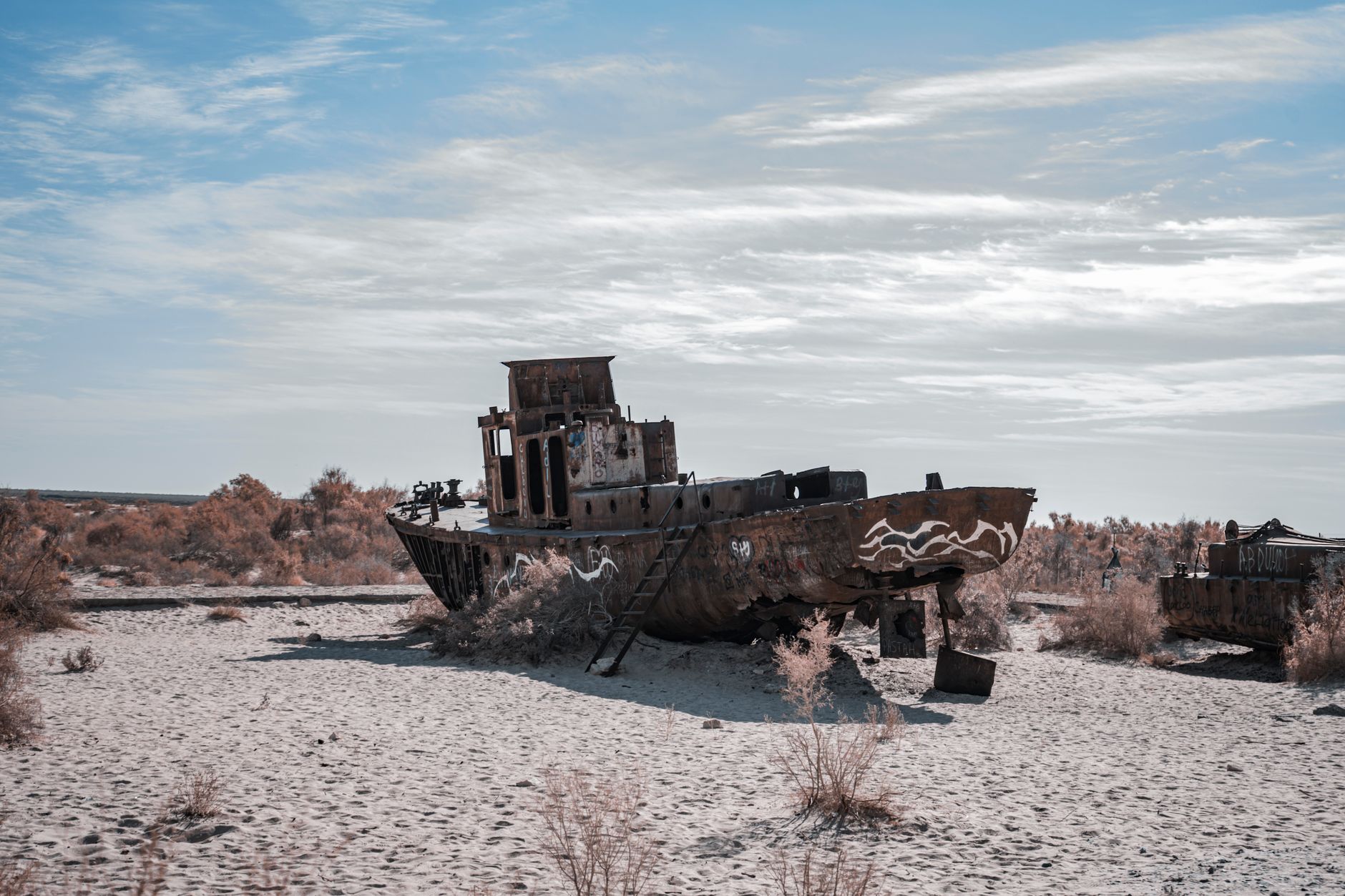 Rusted ship stranded in the Aral Sea desert, a poignant reminder of ecological disaster · Muynak & the Aral Sea, Uzbekistan