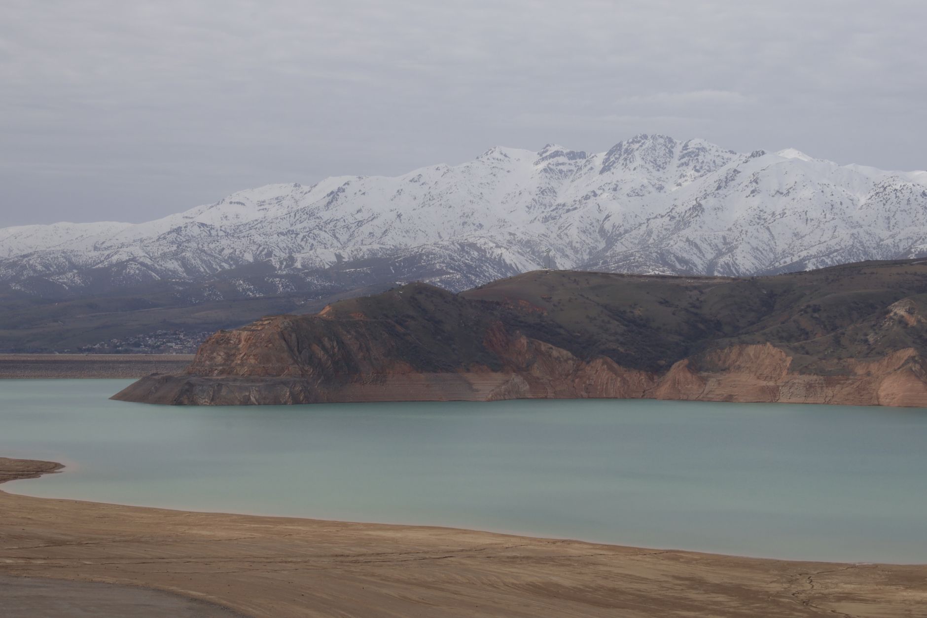 Mountain lake set against stunning snow-capped mountains · Nurata & Aydarkul, Uzbekistan