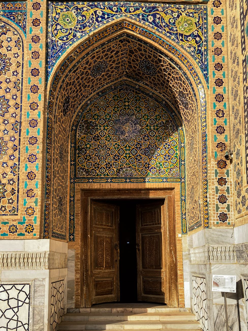 Ornate entrance of a historic building in Samarkand, showcasing stunning Islamic architectural design, Uzbekistan