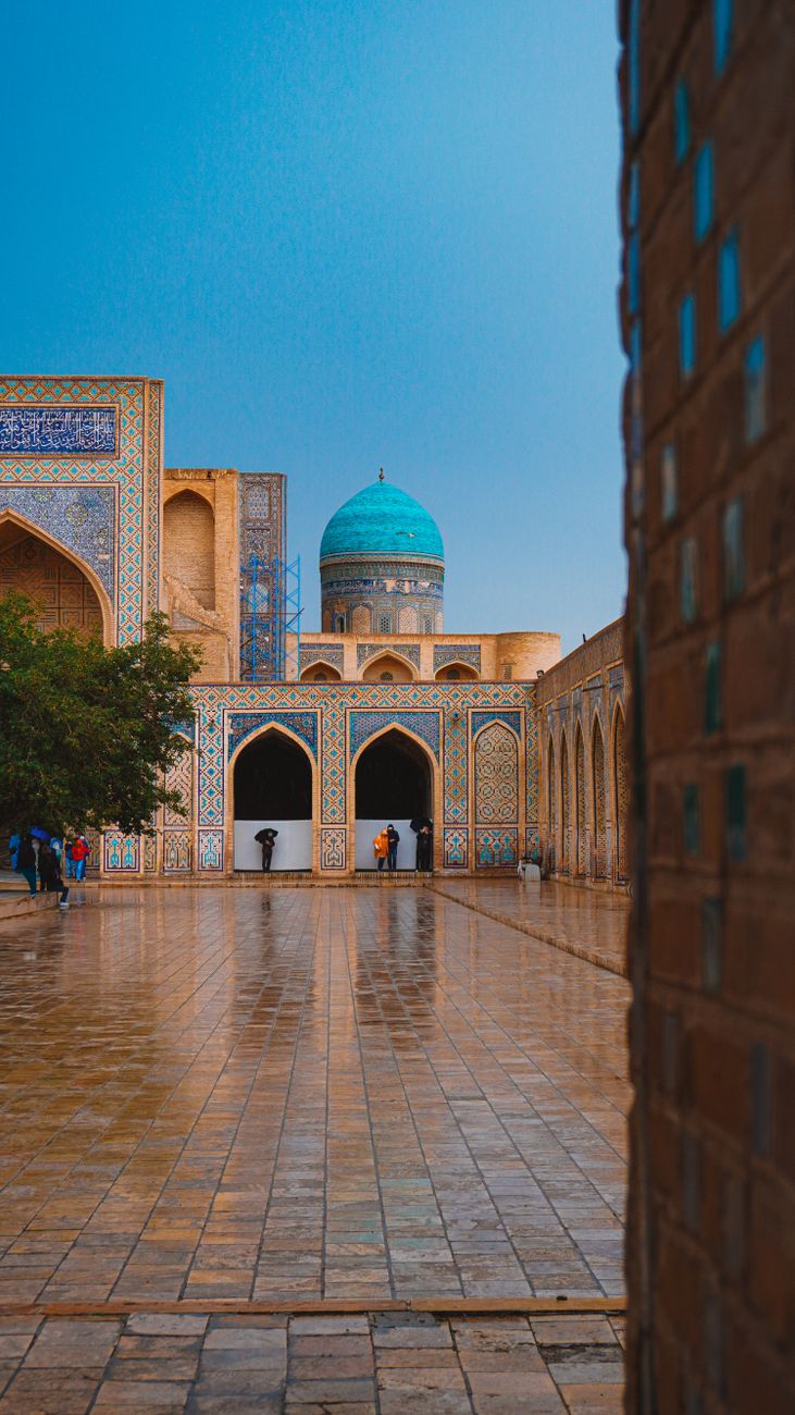 Stunning architecture of a historic madrasa in Bukhara, Uzbekistan, showcasing vibrant blue tiles · Shakhrisabz, Uzbekistan