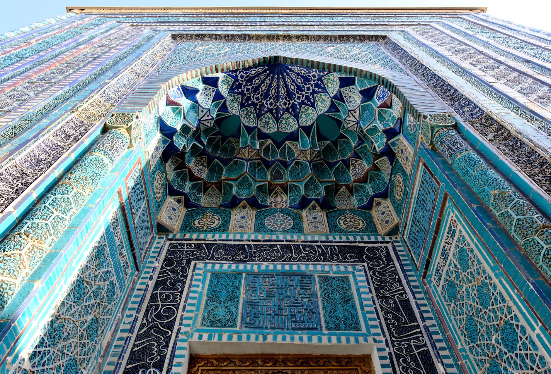 Intricate blue and turquoise Islamic tiles on a building facade, Uzbekistan